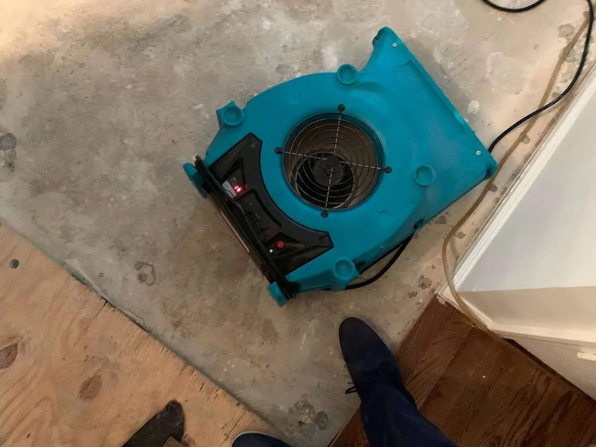Air mover drying subfloor during Leak Detection & Repair in Pike Creek Valley